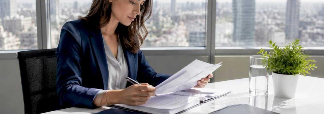 Businesswoman reviewing legal documents in office