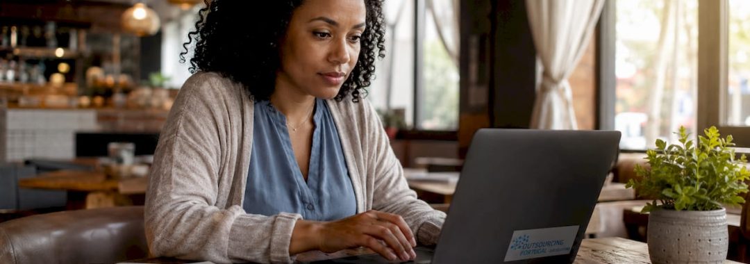 Woman typing remote role outcomes at home office