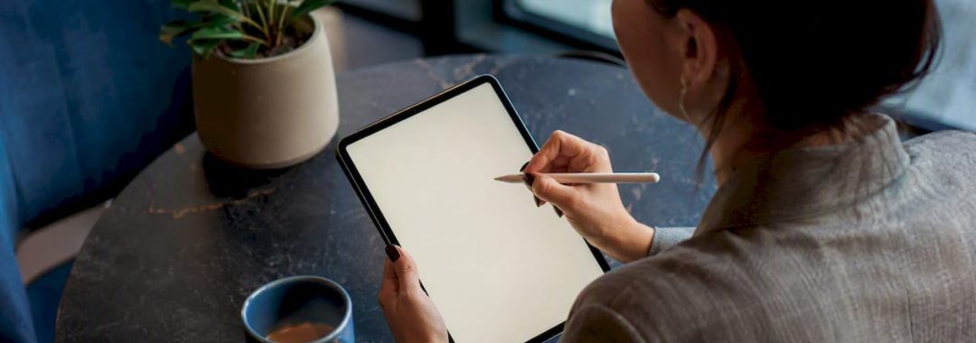 Person drafting IT job description on tablet