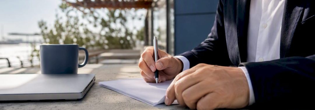 Hands signing temporary work contract