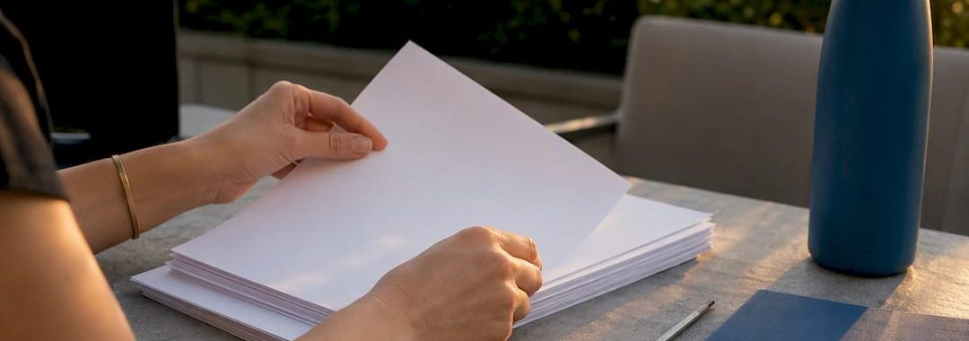 Hands organizing compliance files and calendar